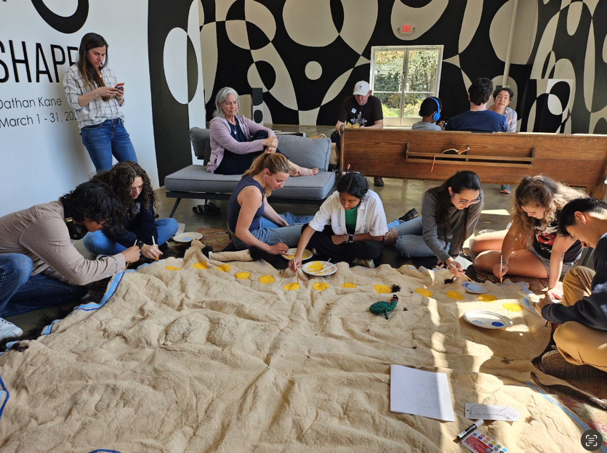 Students paint buffalo robe