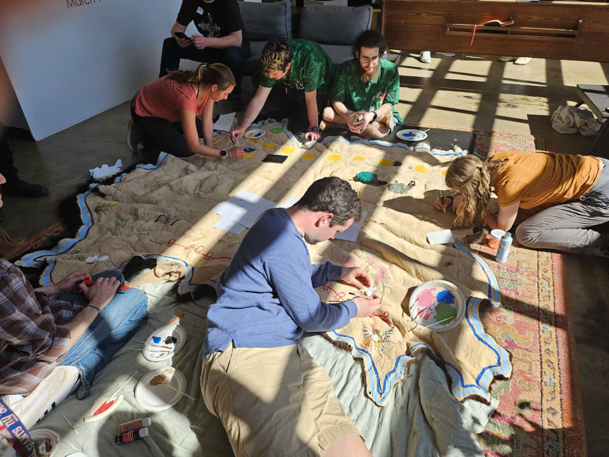 Students paint buffalo robe